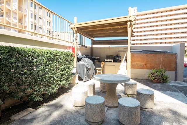 view of patio / terrace with a jacuzzi and grilling area