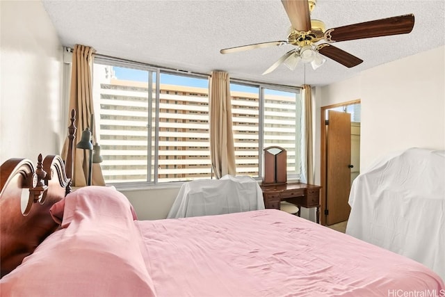 bedroom with a textured ceiling and a ceiling fan