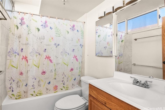 bathroom featuring vanity, toilet, and shower / bath combo with shower curtain