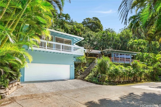 view of front of property with a balcony and a garage