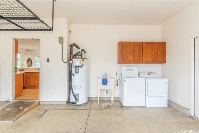 laundry area featuring water heater, a sink, cabinet space, and washing machine and clothes dryer