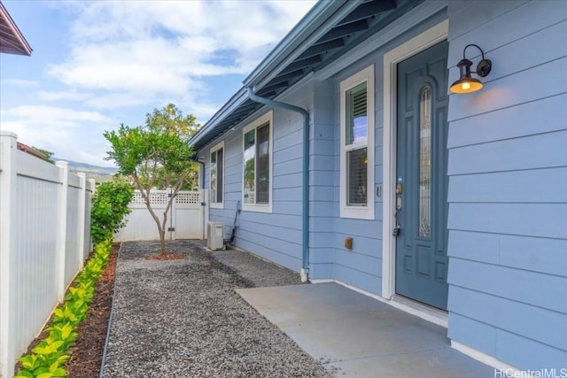 exterior space featuring central AC unit and fence