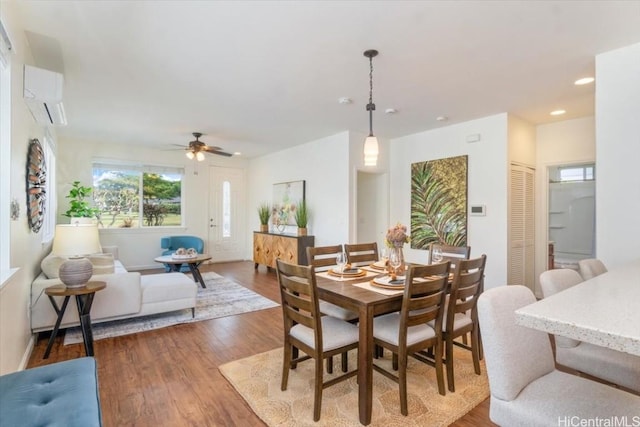 dining room with recessed lighting, wood finished floors, and a wall mounted AC