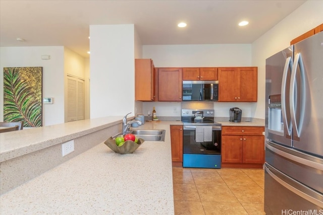 kitchen featuring light tile patterned floors, recessed lighting, a sink, stainless steel appliances, and light countertops