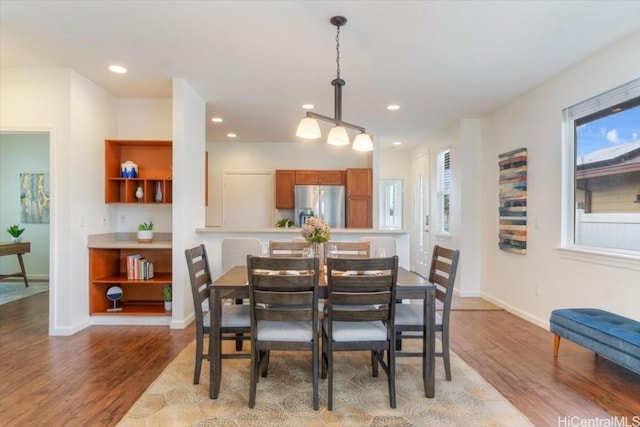 dining space featuring recessed lighting, baseboards, and wood finished floors