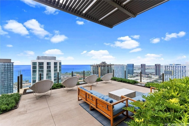 balcony featuring a water view, an outdoor living space, and a city view