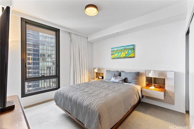 bedroom featuring baseboards and light colored carpet