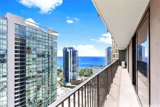 balcony featuring a water view and a view of city