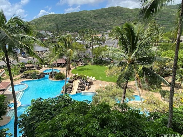 community pool featuring a lawn and a mountain view