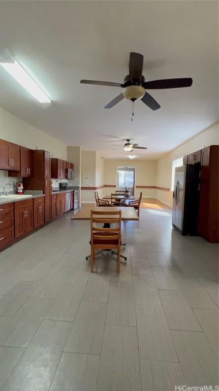 dining room featuring sink and ceiling fan