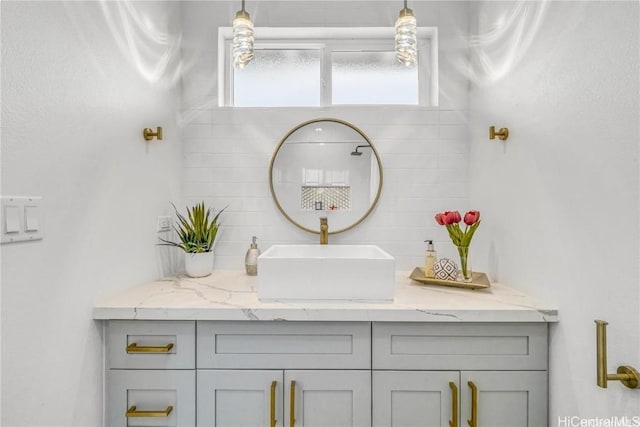 bathroom featuring vanity and decorative backsplash