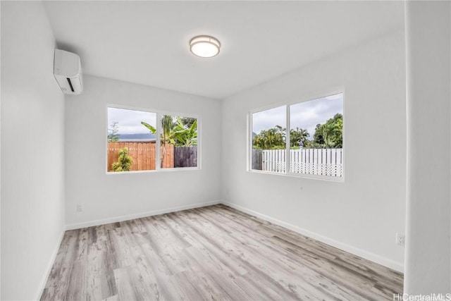 spare room with light hardwood / wood-style flooring and a wall mounted AC