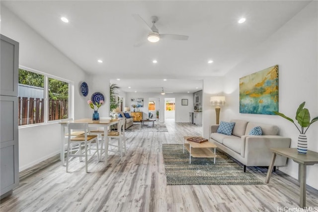 living room with ceiling fan and light hardwood / wood-style floors