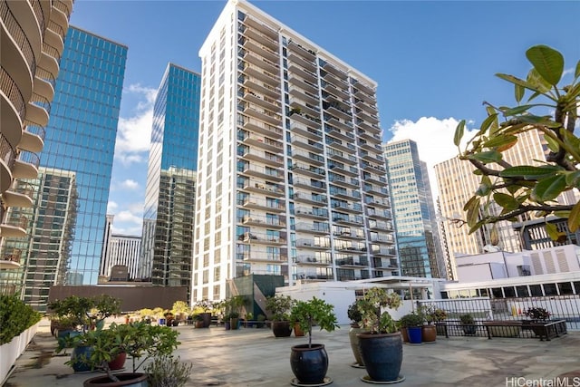 view of property featuring fence and a city view