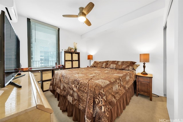 bedroom with a ceiling fan, light colored carpet, and a wall mounted AC