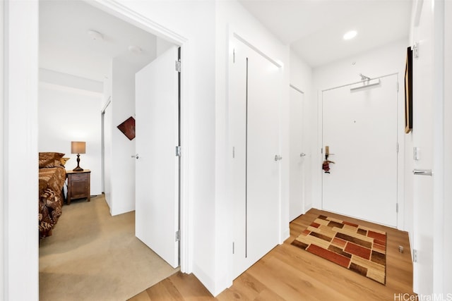 hall with recessed lighting and light wood finished floors