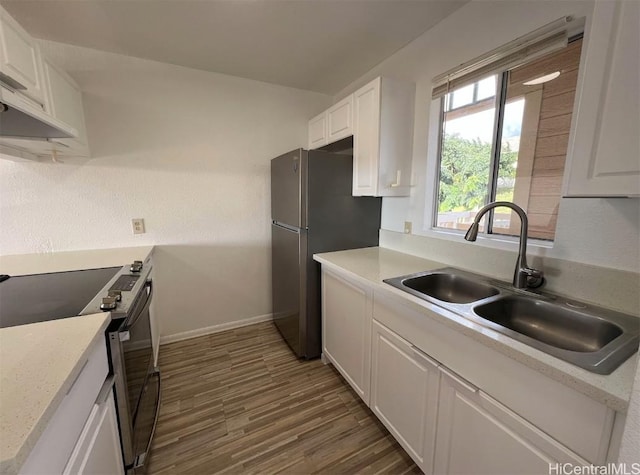 kitchen featuring white cabinetry, appliances with stainless steel finishes, dark hardwood / wood-style flooring, and sink