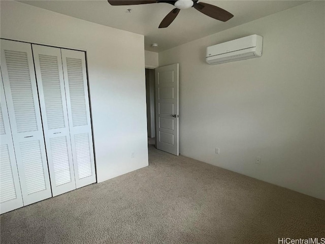 unfurnished bedroom featuring carpet, a closet, a wall mounted air conditioner, and ceiling fan