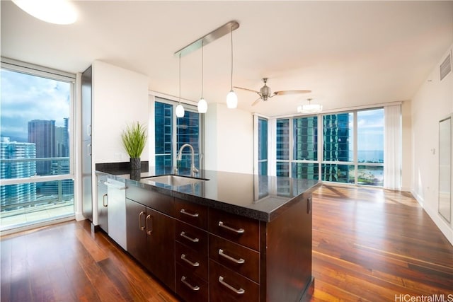 kitchen featuring sink, expansive windows, hanging light fixtures, and dark hardwood / wood-style floors