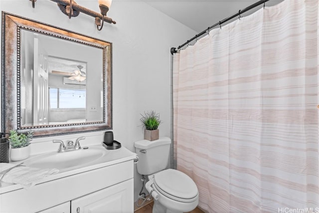 bathroom with toilet, vanity, and curtained shower