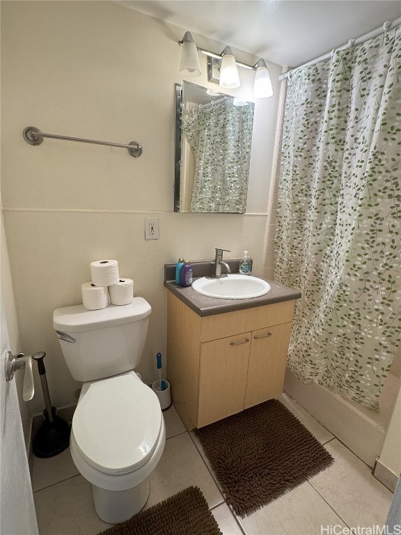 bathroom with vanity, toilet, and tile patterned floors