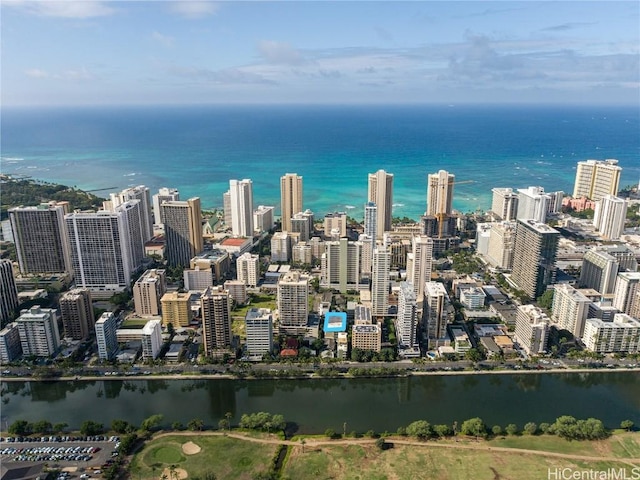 birds eye view of property with a view of city and a water view