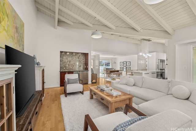 living room with wooden ceiling, light wood finished floors, and beamed ceiling