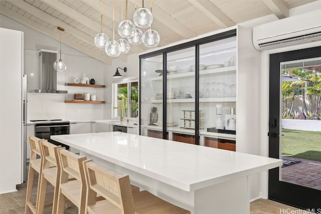 kitchen featuring vaulted ceiling with beams, open shelves, tasteful backsplash, an AC wall unit, and extractor fan