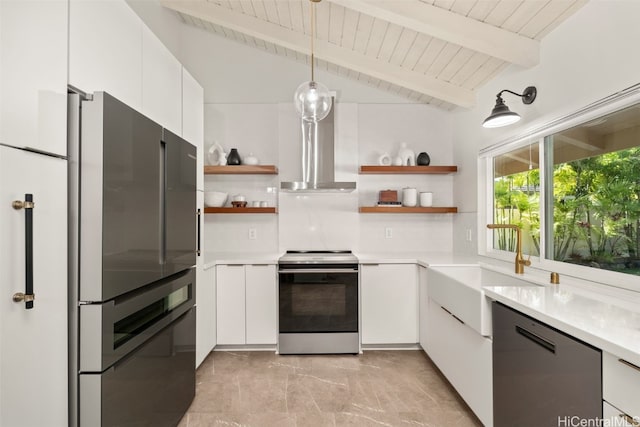 kitchen featuring open shelves, appliances with stainless steel finishes, wall chimney exhaust hood, and white cabinets