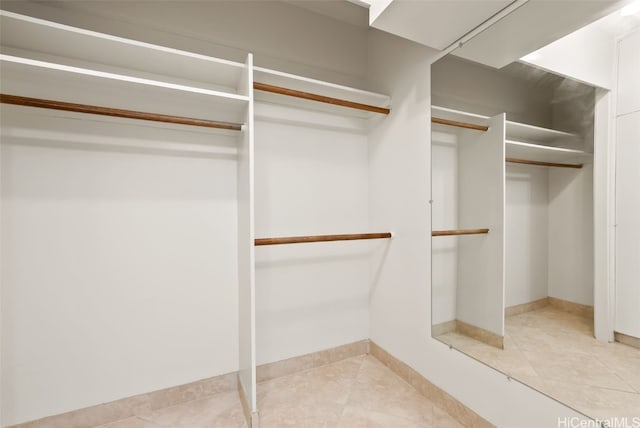 spacious closet featuring light tile patterned floors