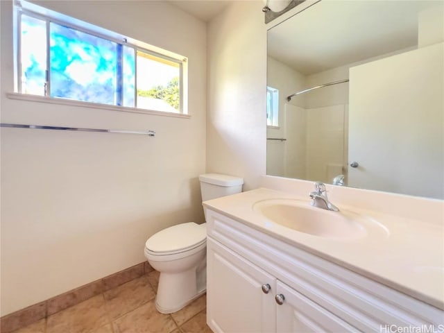 bathroom with a shower, vanity, toilet, and tile patterned floors