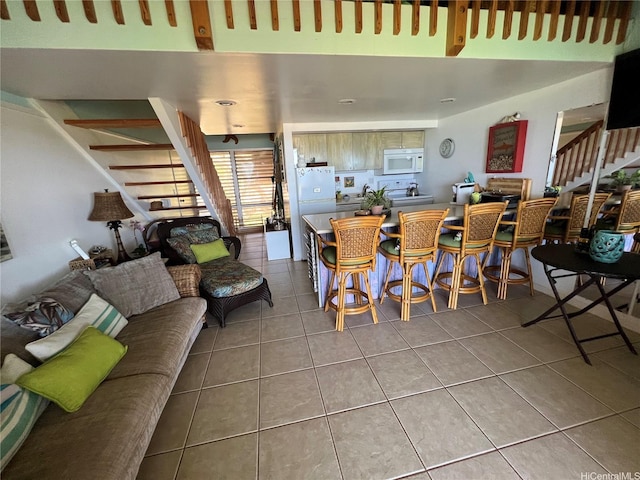 dining room with tile patterned flooring and stairway