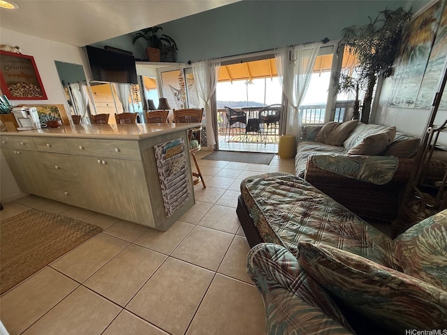 kitchen with light tile patterned flooring and a kitchen bar