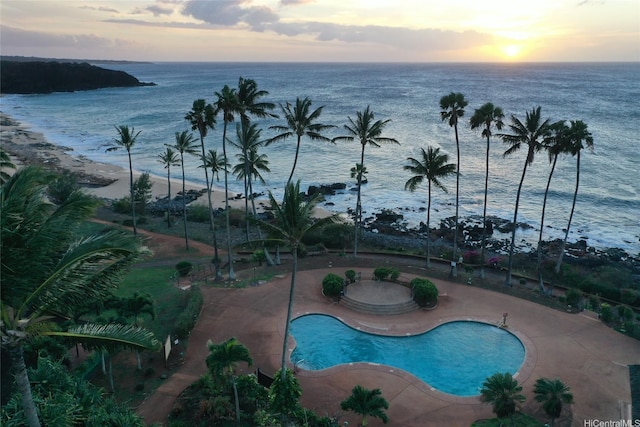 community pool featuring a patio and a water view