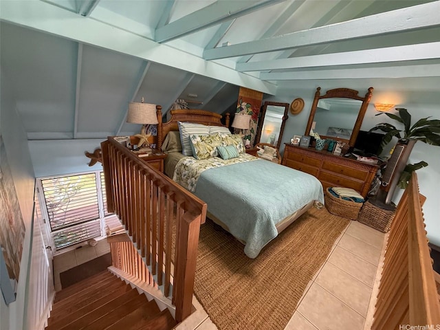 tiled bedroom featuring vaulted ceiling with beams