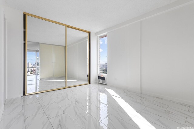 1617 Keeaumoku St Unit 1405, Honolulu, HI 96822 - spare room featuring marble look tiles and a view of city