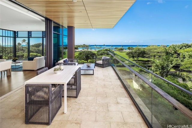 balcony with a water view and outdoor lounge area