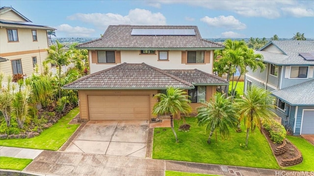 view of front of property featuring concrete driveway, a front lawn, a tiled roof, roof mounted solar panels, and a garage