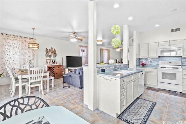 kitchen featuring visible vents, a ceiling fan, a sink, white appliances, and white cabinetry