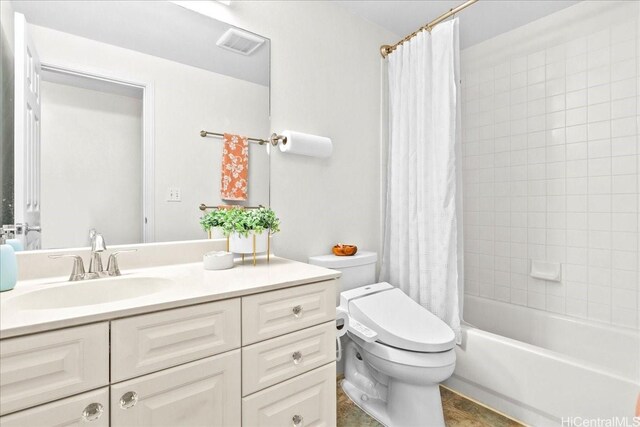 full bathroom with visible vents, toilet, vanity, and shower / tub combo