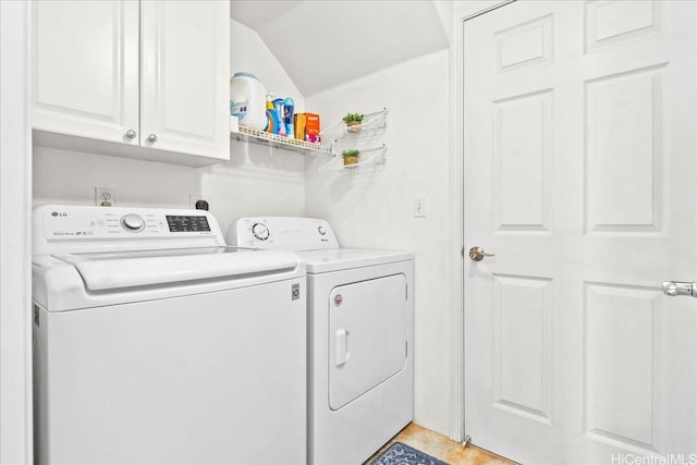 laundry room featuring washing machine and clothes dryer and cabinet space