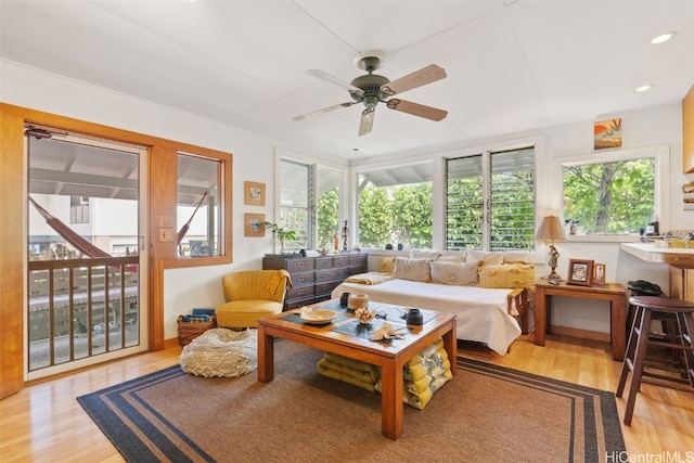 sunroom / solarium featuring a ceiling fan