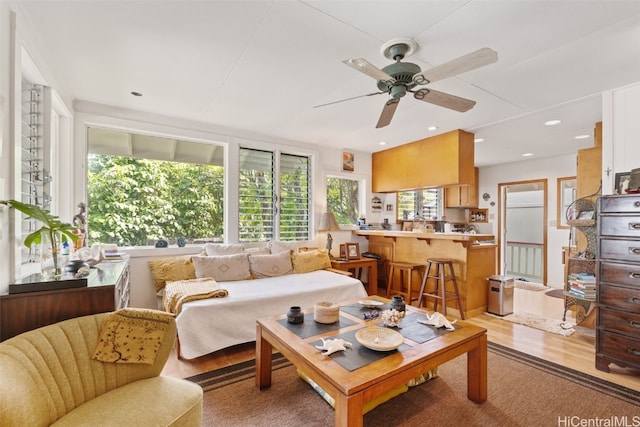 living area with recessed lighting, light wood-style flooring, and a ceiling fan