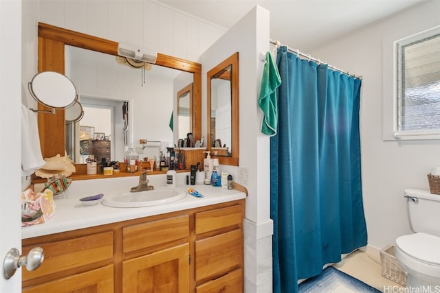 bathroom featuring curtained shower, vanity, and toilet