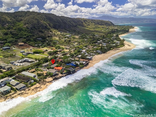 drone / aerial view featuring a beach view and a water and mountain view