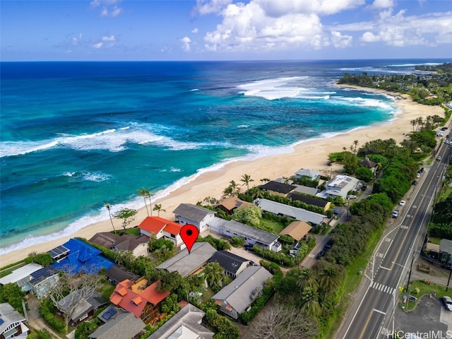 birds eye view of property with a beach view and a water view