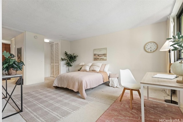 bedroom featuring a closet, light carpet, and a textured ceiling