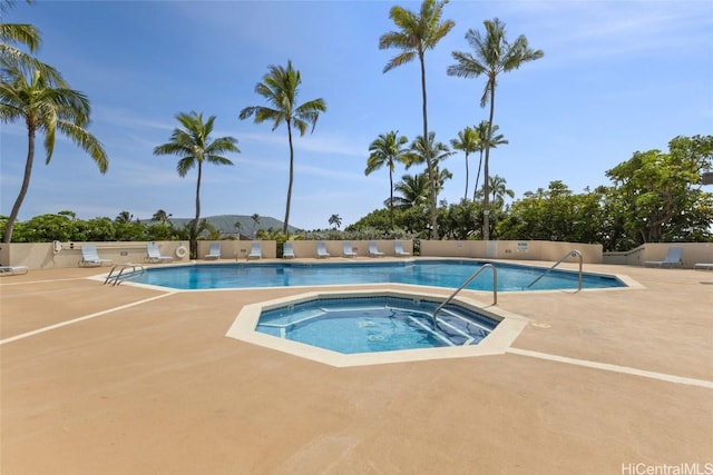 community pool with a community hot tub and a patio