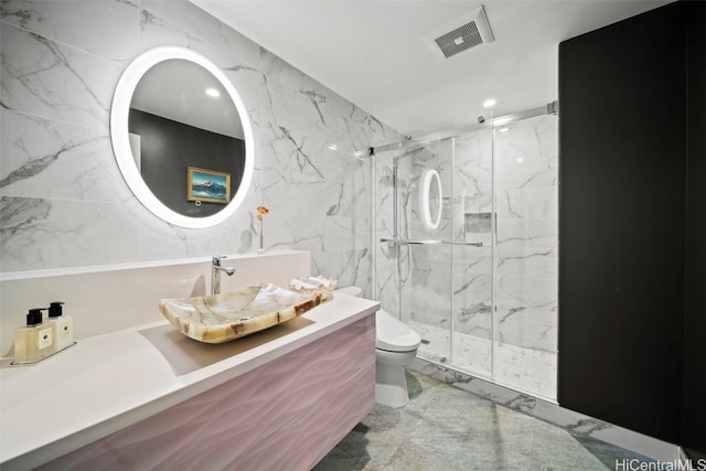 bathroom with stone wall, visible vents, a marble finish shower, toilet, and marble finish floor