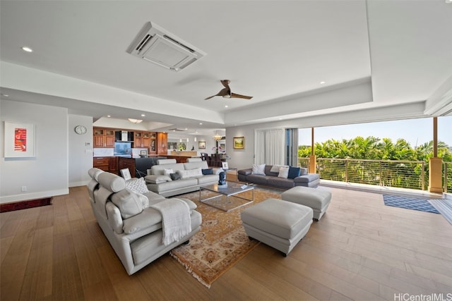 living area featuring recessed lighting, a tray ceiling, ceiling fan, and hardwood / wood-style flooring